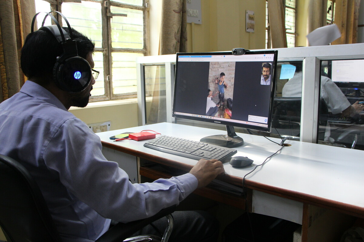 Physiotherapist Hira in a video call with field workers
