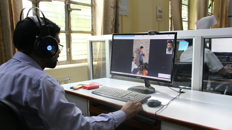 Physiotherapist Hira in a video call with field workers