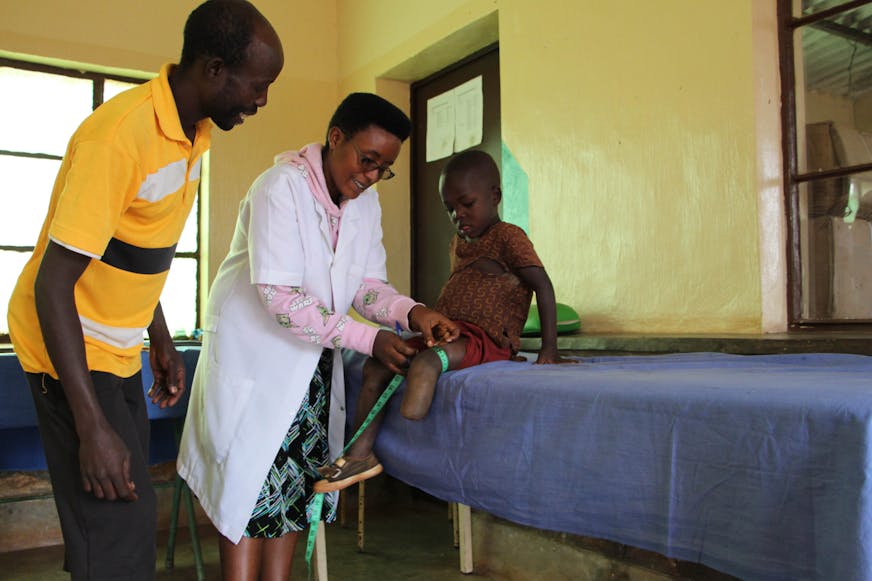 Franck (4) visits a rehabilitation centre for the first time with his father, where he is helped by a physiotherapist