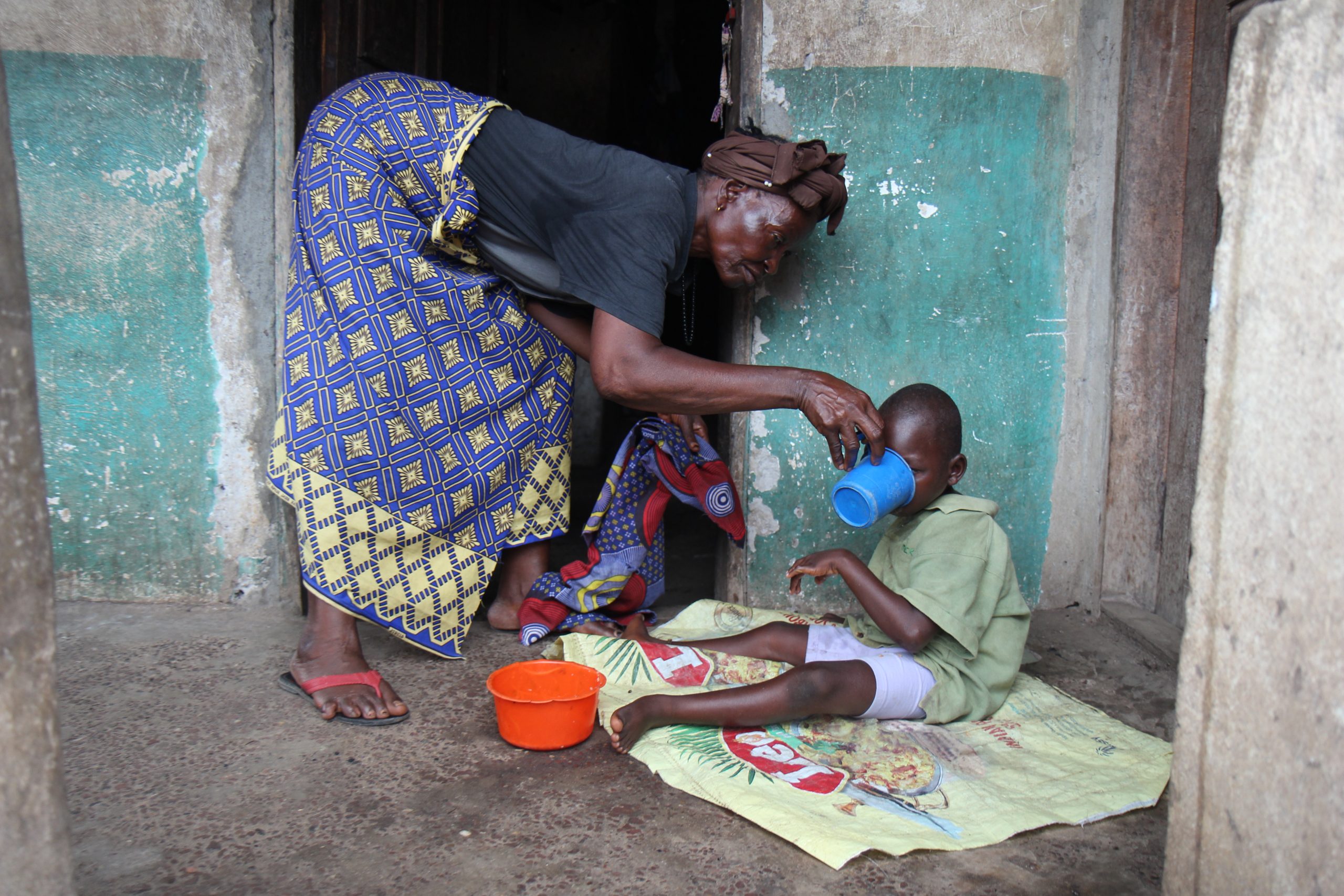 Alhaji’s grandmother gives him a drink